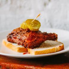 The tongue-lashing chicken from The Budlong is the result of a multi-day, four-part process to create the best texture and flavor for hormone-free local chickens.  A dry brine is followed by a wet dip and a dry dredge, then an overnight rest before the chicken is fried and coated in a top-secret mixture of spices. The restaurant offers hot chicken platters, tenders, a tenders-topped salad and a sandwich, all available Naked, Classic, Hot or X-Hot. The fried chicken sandwiches are the most-popular order. â  Our chicken sandwich is a skin-on breast, fried to perfection and pasted with your desired heat level,â   explains owner Jared Leonard. â  Itâ  s plated on a brioche bun with housemade comeback sauce, housemade pickles and farm slaw.â   Leonard estimates that about 20 people order the X-Hot each day at each of the three locations. For those brave enough to go all in, he recommends balancing out the burn with a cocktail like The Founder, with rum, peach and ginger ale, or the bourbon-based Gentleman Johnson.