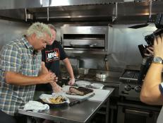 Behind-The-Scenes with Host Guy Fieri About to Taste the Pork Belly Reuben with Chef and Owner Sean Johnson Observing at Meat Southern B.B.Q. and Carnivore Cuisine in Lansing, Michigan as seen on Food Network's Diners, Drive-Ins and Dives episode 2704.
