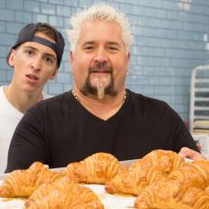Hunter and Guy Fieri with a tray of croissants at La PanderÃ­a cafe in San Antonio, Texas, as seen on Diners, Drive-Ins, and Dives, Season 27.