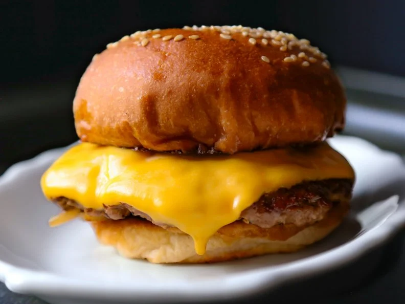 Just down from equally popular sister restaurant Leon’s Fine Poultry & Oyster Shop, Little Jack’s draws rave reviews for a retro tavern-style menu that features their bestselling Tavern Burger. Served on a sesame bun, the burgers are made with a blend of brisket and chuck that’s pressed flat on the plancha and topped with sautéed onions, American cheese, and a sauce made with sunchokes and mayo. It’s available as a “Little Snack” (single patty) and as a sandwich (two patties). For those who prefer savory over sweet, the single patty option is even on the dessert menu (and it’s often ordered). Order a round of caviar and potato chips to start and be sure to get a side of garlic fries, which come with a unique mayo-based gribiche sauce that utilizes hard-boiled eggs.