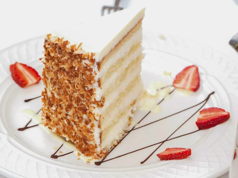 On the menu since Valentine’s Day of 1997, the 12-layer Peninsula Grill Ultimate Coconut Cake® is another Charleston classic. The five-inch tall, 25-pound coconut colossus is actually two cakes cut into three layers each, with fluffy filling, cream cheese icing and toasted coconut pressed into its sides delivering decadent bits without being too sweet or tropical. A huge slice is 1/16 of the cake, but whole coconut cakes are also very popular Charleston souvenirs (and are shipped around the country). It’s the perfect ending to a Peninsula Grill meal, which features Executive Chef Graham Dailey’s exquisite takes on other Charleston classics and more in a classy Lowcountry setting.