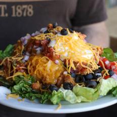 You’ll have diddly-squat for WiFi and a trace cellular signal, so plot the route \ through the scenic Black Hills in advance to devour Indian tacos as big as your steering wheel. The key to Cheyenne Crossing’s legendary specialty is the hot bubbly WoodenKnife Indian fry bread. The toppings — special recipe taco meat and refried beans, shredded cheese, sour cream, lettuce, juicy tomatoes, diced red onions, black olives, house-made picante sauce — are piled on until they tumble off the heap and around the plate; there’s also a vegetarian version with homemade black bean sauce. Cheyenne Crossing serves more than 5,000 Indian tacos during the Sturgis Motorcycle Rally.