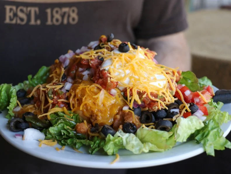 You’ll have diddly-squat for WiFi and a trace cellular signal, so plot the route \ through the scenic Black Hills in advance to devour Indian tacos as big as your steering wheel. The key to Cheyenne Crossing’s legendary specialty is the hot bubbly WoodenKnife Indian fry bread. The toppings — special recipe taco meat and refried beans, shredded cheese, sour cream, lettuce, juicy tomatoes, diced red onions, black olives, house-made picante sauce — are piled on until they tumble off the heap and around the plate; there’s also a vegetarian version with homemade black bean sauce. Cheyenne Crossing serves more than 5,000 Indian tacos during the Sturgis Motorcycle Rally.