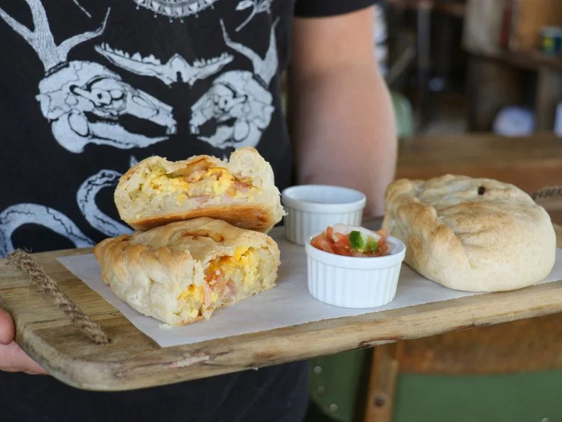 Pasties — savory hand pies — were a lunchtime staple for immigrant workers at the Homestake Mine in Lead, South Dakota. The miners liked the hearty meat-and-vegetable pies because they were satisfying for a long work day and durable enough to withstand the trip underground. The “handle” enabled miners to hold the pasty with dirty hands and toss the dirtied edge away. Harriet and Oak in Rapid City serves two versions made by Bonnie King of Kings Pasties in Lead. One is breakfast-style, with diced ham, cheese, scrambled eggs, and potatoes (best with house-made pico de gallo). The other holds steak and potato. You can’t miss the building: It’s the former Dean Chevrolet dealership, which dates to 1929 and was added to the National Register of Historic Places in 1995.