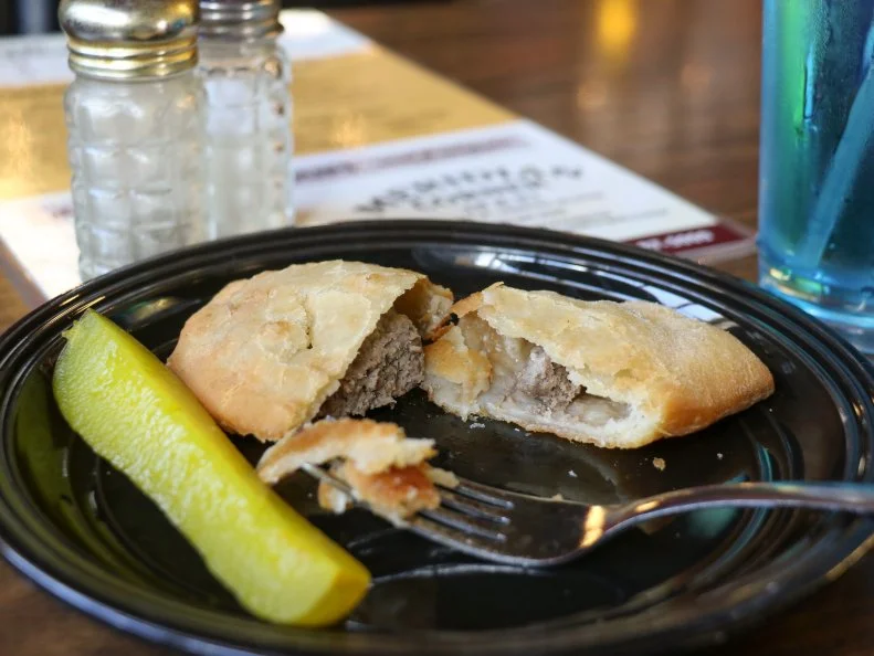Fleisch kuchele is like a burger masquerading as a hand pie. Germans from Russia introduced fleisch kuchele to southeast communities around Menno, Freeman, Viborg and Parker, South Dakota. A pocket of handmade dough is filled with seasoned hamburger and onions and deep-fried to hot, flaky goodness. The meat pies are predominantly served with a side of ketchup and pickle spears. Years ago, restaurants in the area offered fleisch kuchele on their menus, so when the Svartoien family opened Meridian Corner in the 80s, they added it to theirs. They are now one of the few establishments in the state that still serve the dish.
