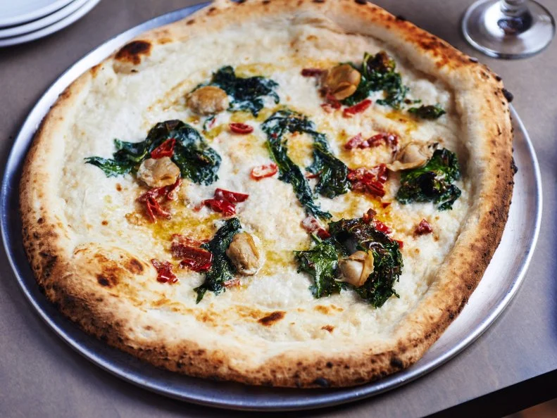 At the heart of Nicky’s Coal Fired, an upscale pizza joint in The Nations, sits a blistering-hot oven, lovingly named Enrico. The glowing-red inferno perfectly sears artisanal pizzas, and also cooks up a collection of small plates and pastas, which round out the menu, including chicken thighs and brussels sprouts. Chef Tony Galzin, a Chicago native, brings his Italian heritage to the forefront, making his pastas and charcuterie in-house. The pizzas, arguably the stars of the menu, are based on either red or white sauce and might be topped with anchovies and capers or potatoes, cured egg yolk, and mozzarella. A selection of vermouths, wines on tap, and a strong cocktail list add to the fun.