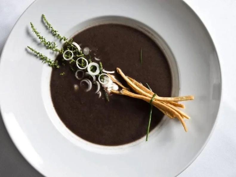 “Mexican food” often conjures cravings for enchiladas and tacos, but at Sazón, it means something else entirely. The small, focused menu includes exceptional dishes based on New-World Mexican cuisine. As Chef Fernando Olea describes, the cuisine at Sazón is “going from the Aztec roots to nouvelle cuisine with flavors of Mexico.” Appetizers include huitlacoche, a corn fungus that was eaten by the Aztecs, and taquitos with grasshoppers (chapulines). The stars of the menu, however, are Olea’s moles, a variety of which are presented nightly as specials. Sazón is also a mezcaleria and tequileria, with comprehensive lists of both spirits. 
