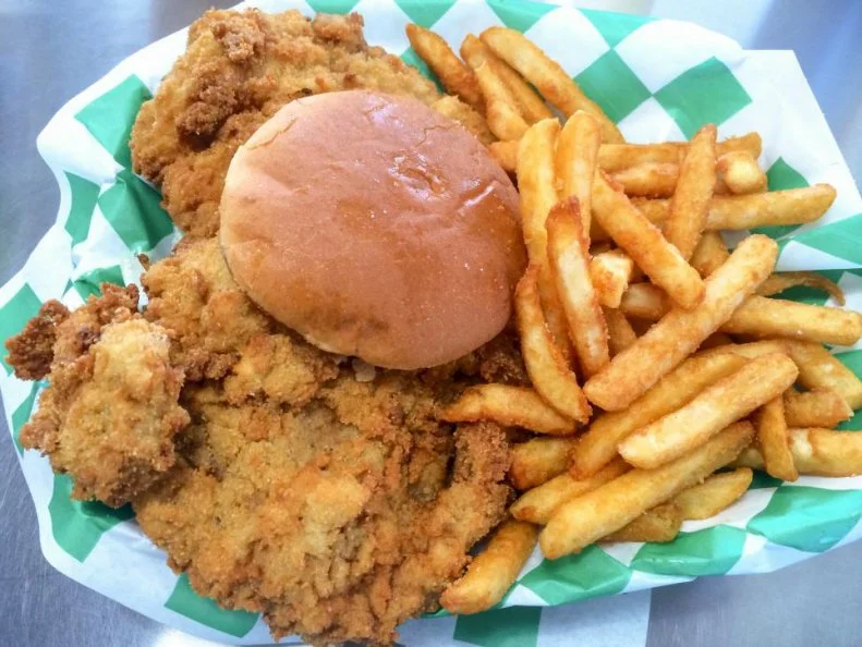 Hog-friendly Indiana knows how to pile pork onto a sandwich. The unofficial Hoosier State sandwich is deep-fried, breaded pork tenderloin on a bun, beloved in restaurants and home kitchens from Lake Michigan to the Ohio River. The Mug, a "farm-to-curb" drive-in in Greenfield with a second location in Indianapolis, is one of the top places to take a bite. Made from local, pasture-raised hogs, the pork is pounded thin, breaded, deep-fried and set on a strikingly small bun. The overhanging tenderloin is like the food equivalent of Chris Farley's fat guy in a little coat, which is part of what makes people love it so much.