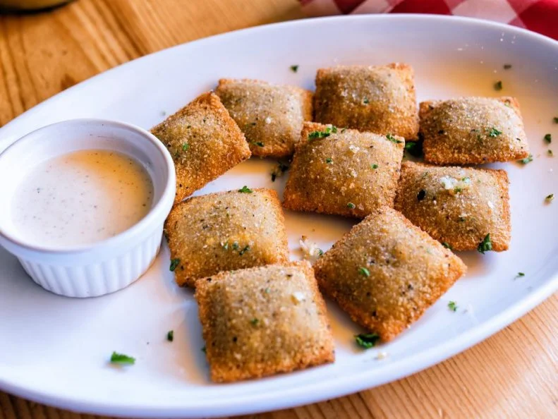 In a state known for its deep-fried cheese curds and burritos, toasted ravioli â   which are not toasted at all â   may be the most-iconic deep-fried dish of all. While it is a total misnomer, the dish is just as it sounds: crispy, breaded ravioli filled with meat and typically served with marinara sauce. At St Louis barbecue spot Salt + Smoke, toasted ravioli gets a wood-smoked spin, with a filling of chopped oak-smoked burnt ends inside, a dusting of garlic and herbs outside and Alabama-style white barbecue sauce for dipping.