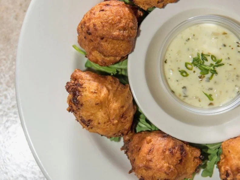 This third-generation family-owned diner is a seafood-loverâ  s Shangri-La. Just minutes from the beach, Aunt Carrieâ  s serves straight-out-of-the-sea platters of steamed clams, lobsters, clam bellies and more with a view of Point Judith Lighthouse on the horizon and a briny ocean breeze wafting through the air. The deep-fried clam cakes are a staple. The kitchen goes through so many on a summerâ  s day, a large cement mixer is used to prepare the batter. Balls of chopped clams, flour, water and seasoning are dropped into searing beef shortening until perfectly chewy and crisp, and the perfect New England answer to crab cakes.