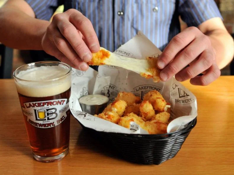 Before cheese is formed into blocks or wheels, it starts out as cheese curds. The small chunks, which are the basis for Wisconsinâ  s famed cheddar, are mildly flavored and salty with a nice springy bite. Theyâ  re also delicious deep-fried and plunged into assorted dips. Ceaselessly snackable, fried curds are revered among Wisconsinites, especially when beer is involved. Theyâ  re found on bar and brewpub menus across the state such as Lakefront Brewery in Milwaukee, where squeeky Clock Shadow Creamery curds are battered, fried and served with garlic ranch.