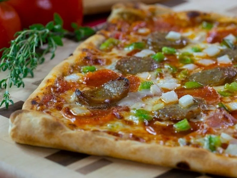 Though it might not be as well-known as Chicago or New York, Omaha has its own specific style of pizza, and you’ll find it at La Casa Pizzeria, an old-school shop with an incredible neon sign out front. The crust is rich and sort of flaky, a buttery biscuit-like concoction served in a giant rectangle and cut into squares. The most-popular topping combination is a layer of ground beef topped with onions and mushrooms. The tomato sauce is thin and bright, hidden between the crust and meat. 