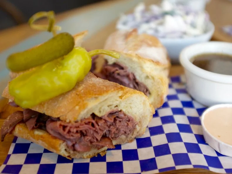 This tiny sandwich shop makes a big impression with its gourmet sandwiches built on freshly baked bread and priced at $10 or less. One standout is the French dip (named for the prior owner of the shop, Clare) piled high with paper-thin slices of rare roast beef blanketed in a gooey layer of melted Gruyere cheese. This prime-for-sharing stunner is so hefty that it’s cut in three pieces rather than two. In addition to the customary side of hot au jus for dipping, the sandwich also comes with a creamy, cool horseradish sauce.
