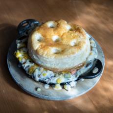 The Mason Jar's signature dish 10, 000 Lakes Hotdish in a cast iron skillet, as seen on The Grill Dads, Season 1.