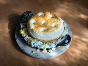 The Mason Jar's signature dish 10, 000 Lakes Hotdish in a cast iron skillet, as seen on The Grill Dads, Season 1.