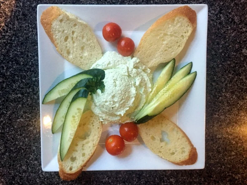 Benedictine was created in the early 1900s, when Jennie Carter Benedict of Benedict’s Restaurant whipped up a cucumber-mayo-cream cheese dip. The refreshing, crunchy combination caught on quickly. Today, it’s often served in tea sandwiches at Derby parties, weddings and baby showers, and on sandwiches or alongside charcuterie and cheese boards on restaurant menus. At Louisville classic Bristol Bar & Grille, Chef Austin Wilson blends peeled and seeded cucumbers with cream cheese, onion puree, mayo, Tabasco and a dash of food coloring — a customary addition that gives the dip its signature green tint. The versatile spread lends itself to creative additions, like smoked jalapenos or pimento cheese, and shows up on the menu just about everywhere.