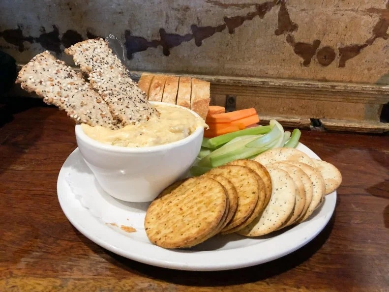 Maryland’s crab cakes get all the glory, but in Baltimore, crab dip gets near-equal billing. Interpretations vary, but at Mama’s on the Half Shell, the inspiration comes from the main menu. After the kitchen ran out of room to include a crab-and-artichoke entrée, the team decided to craft the flavor profile into the crab dip. The cheesy dip features cream cheese, cheddar, Boursin and smoked Gouda, all seasoned with Old Bay and then folded with artichoke quarters and sweet crab claw meat. It’s baked until bubbly and served with crackers, celery, carrots and sliced bread.