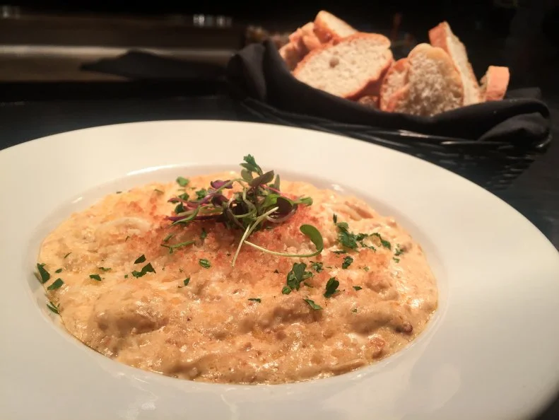 At steakhouse and bourbon bar The Single Barrel, Chef Brandon Harpster invented a novel way to satisfy Nebraskans’ love of sausage and cream cheese-style dips in one fell swoop using his own Italian chicken sausage. Seasoned with fennel, coriander, cayenne and red pepper, the sausage is sautéed with onions and peppers until crumbly, then mixed with cream cheese, white wine and a dash of sambal for added heat. The dip is blanketed with buttery breadcrumbs and served hot with tortilla chips, crostini and vegetables. The dip is always available, but orders go through the roof during Nebraska Cornhusker home games, when the restaurant takes on a tailgate atmosphere.