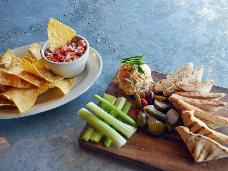 Black-eyed pea caviar is a typical side at BBQ joints state-wide, but at Oklahoma City’s Iron Star Urban Barbecue, it takes a starring turn as a dip for tortilla chips. Also known as cowboy caviar, the black-eyed pea caviar is a relish-like medley of black-eyed peas, peppers, onions and scallions, dressed with lemon, vinegar and a hint of tobacco. It’s often ordered alongside the pimento cheese, another Southern staple that’s a fixture at tailgating and weddings alike. Owner Keith Paul’s version features a duo of cheeses, mayo, cream cheese and smashed pimento peppers, plus charred jalapenos for a smoky-spicy hit. Layer the pimento and cowboy caviar on top of the accompanying grilled toast for a double dose of Southern dipping nirvana.