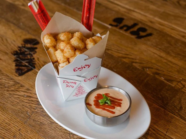 Pimento cheese is a Southern staple, served with buttery crackers and celery sticks at gatherings for all occasions or slathered onto sandwiches, burgers and biscuits. At Greenville’s Southern Culture Kitchen & Bar, owner Chad Gangwer gilds the lily by turning the caviar of the South into a pot of liquid gold. The pimento cheese fondue features standard yellow cheddar, but for added cheesiness and flavor, it also incorporates aged sharp white cheddar, pepper Jack and Parmesan Reggiano, all mixed with heavy cream and sautéed onions, then kicked up with cayenne, smoked paprika, horseradish and ground mustard. The fondue is served with tater tots for dipping, but also makes a cameo in the baked skillet macaroni and atop pulled-pork nachos.