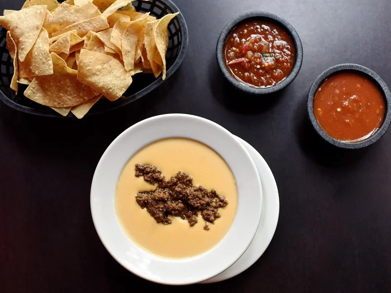 In Texas, chile con queso, a spicy molten cheese dip known simply as queso, is a Tex-Mex staple that shows up seemingly everywhere, including restaurant menus, potlucks and family gatherings. At Molina’s Cantina in Houston, the chile con queso gets a meaty upgrade in The Original Jose’s Dip, named for a former waiter who garnished queso orders with taco meat. The dip became so beloved that diners asked for José’s Dip even when he wasn’t working; it remains a menu staple and fan-favorite today. The dip stars Velveeta — prized for its smooth meltability — as well as a spice blend that’s so secret you can’t even marry into it, and a hefty scoop of zesty ground beef taco filling bolstered with crushed garlic, cumin and cayenne. It’s accompanied by fresh tortilla chips, three house-made salsas and a bowl of carrot escabeche.