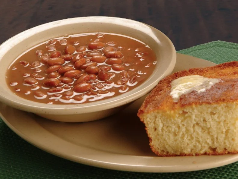 Tudor’s Biscuit World is lauded for its namesake buttermilk biscuits, but the West Virginia chain-let (which now counts locations in Ohio, Kentucky and Florida, too) couldn’t launch a restaurant in the Mountain State without including a classic West Virginia duo on its down-home menu. Pinto beans and cornbread is a traditional country combo; historically, the easy, filling dish was a staple in mining communities. At Tudor’s, the pinto beans are slowly simmered with a top-secret blend of spices and “grandma’s secret ingredient,” served in a bowl with cornbread and a side of chopped sweet onions. While styles of eating the iconic duo vary, it’s common practice to dunk squares of the buttery, crumbly cornbread into the deep-set bowl of beans and sop up the flavorful simmering liquid. The dish makes a fine addition to any meal, but is particularly appealing when winter comfort food cravings beckon.
