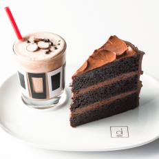 As if a slice of chocolate cake weren’t decadent enough on its own, the one at Denver’s D Bar comes with a milkshake. The pairing is one of pastry chef Keegan Gerhard’s many nods to childhood cravings — others include milk with cookies and root beer floats. This particularly gluttonous duo features a slice of Gerhard’s three-layer cake — the layers separated by frosting made from Guittard chocolate — and a shake spun from your choice of housemade vanilla, chocolate or raspberry ice cream.