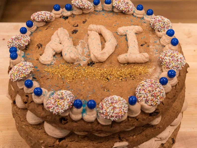 Contestant Aditya Pillutla's completed cookie cake dish from the main heat challenge, Spiced Oatmeal Rasin Cookie Cake with Chocolate Hazelnut Spice Buttercream, as seen on Food Network's Kids Baking Championship Season 4