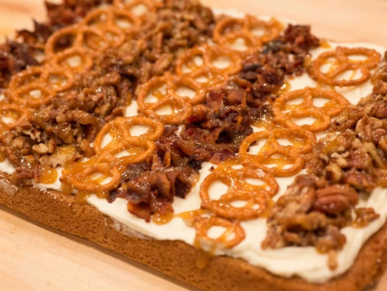 Abby's blondie crust w/ maple cream cheese frosting and candied pecans, caramel pretzels, and bacon, as seen on Kids Baking Championship, Season 4.