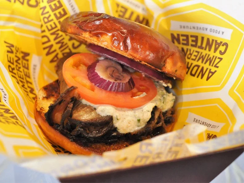 Andrew Zimmern has been knocking it out of the park at Target Field, home of the Twins, for years, so Vikings season ticket-holders were elated to welcome his fare to USB Stadium (section 121). The Lamb Sandwich is one of the best bites in the stadium. Cumin-marinated, slow-roasted lamb shoulder, thinly sliced, slathered with a lively cucumber-Greek yogurt sauce and served on a worthy bun, this sandwich hits right between the goal posts. For those at home, grill our own lamb for Guy’s five-star sandwiches.