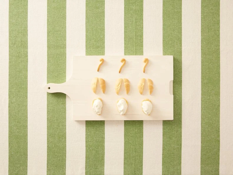 Making Cream Puff Animals - Cream Puff Swan: Piping dough into shapes, then baking, slicing, and filling with pastry cream to create cream puff swans for Eatertainment, as seen on Kids Baking Championship, Season 2.