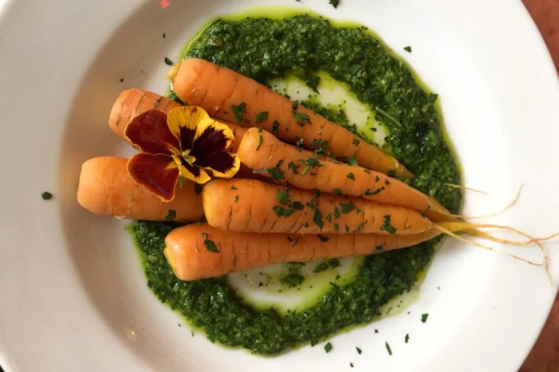 Despite the widespread popularity of Spanish tapas menus, they've remained a bit of a minefield for vegetarians. Not so at Iowa City's 20-plus-year-old Devotay, where the small-plates lineup is informed by a daily produce shipment from Green Share Co-op. With a menu that includes the likes of poached carrots with almond pea-shoot pesto and Noble Bee honey, crispy poached eggs with red-wine caramel, baked Old Capital tofu with sauteed mushrooms, and grilled summer squash showered with Manchego cheese, there's no reason for the meat-free to subsist on patatas bravas here.