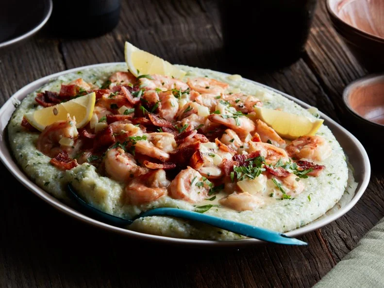 Andouille Sausage, Garlic, Yellow Onion, Dry White Wine, Chicken Broth, Milk, Grits, Thyme, Cherry Tomatoes, Green Bell Pepper, Shrimp, Cajun Seasoning, Hot Sauce, Chives