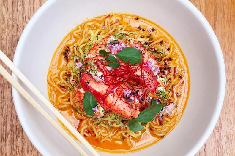 Chef Brandon Kidaâ  s butter lobster ramen at Hinoki & the Bird has received raves from press and diners alike. Kida starts by butchering a fresh live lobster, removing all of the meat and using the shells to make a richly flavorful lobster broth. While the broth is reducing, Kida makes the ramen noodles by hand and then poaches the lobster meat in boiling butter. Too rich to serve during the summer, this dish is available in fall, winter and spring. In winter a thick slice of pork belly is added, turning it into an even heartier meal in a bowl.