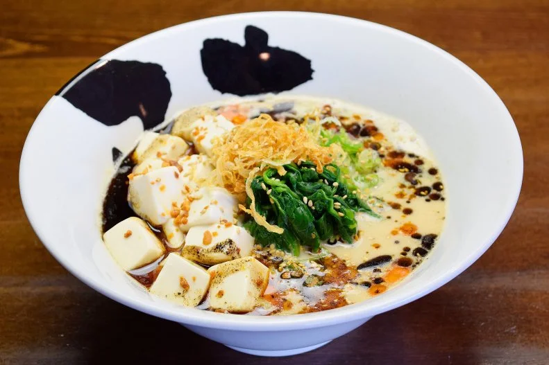 Tomonori Takahashi opened his first Jinya in Tokyo in 2000 and his first in California 10 years later. The restaurant offers something for everybody: 13 signature ramen bowls; thick, thin and spinach dry-aged noodles that take three days to make; four kinds of broth simmered for over 10 hours; and more than two dozen toppings. The luscious Spicy Creamy Vegan Ramen features vegetable broth, tofu, onion, scallion, spinach, crispy onion, garlic chips, garlic oil, chili oil and sesame seeds, served with thick noodles. The chain is rapidly expanding across the United States and Canada, and currently has more than 25 locations.