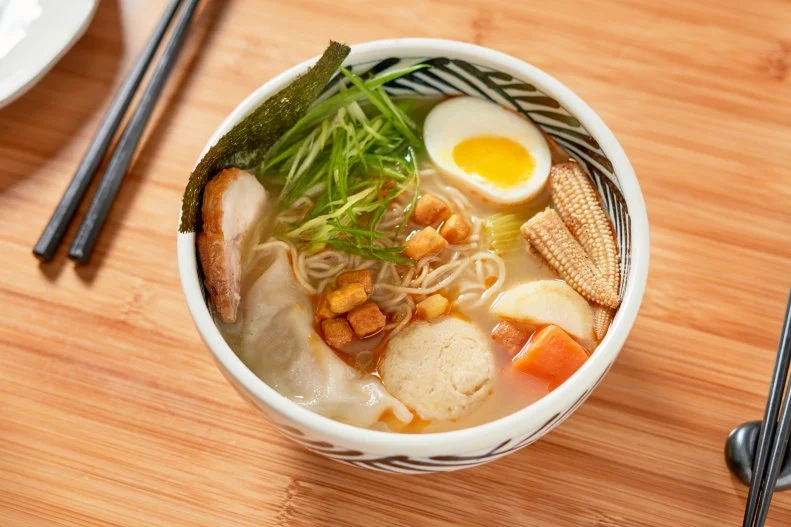 After hearing the name Shalom Japan, you won’t be surprised to learn that the chef-proprietors are Aaron Israel from New York and Sawako Okochi from Hiroshima. Their menu beautifully blends Jewish and Japanese traditions in dishes like okonomiyaki with sauerkraut and pastrami, a lox bowl with rice and Japanese pickle, and their signature ramen: a matzo ball, a foie gras dumpling, pieces of chicken, and vegetables like scallions and baby corn, all cooked in a chicken soup base that imbues the matzo ball with its flavor.