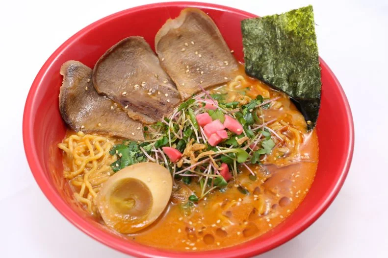 Yokohoma Ramen chef-owner Yasunari Fukuda is from Yokohama, Japan, and shares his home style of ramen as well as his own creations at the shop he opened in 2016. The B.T.T.M., or spicy beef tongue tantanmen, is his newest offering, a combination of a spicy miso base mix with a secret savory broth. The beef tongue is cooked for four hours and marinated with the chefâ  s special sauce overnight, and the bowl includes local farm-to-table micro sprouts and homemade pickled radish. The shop also offers habanero garlic ramen, black garlic ramen and great vegan options.