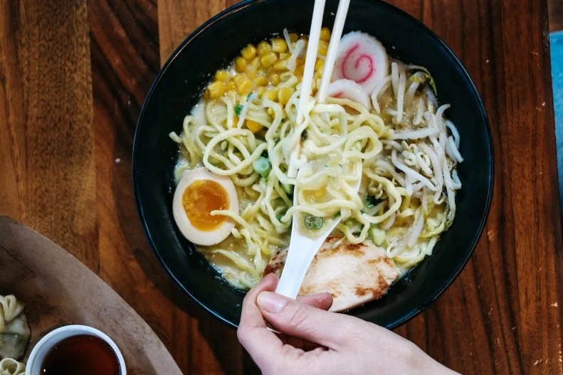 Ramen has taken hold in the heartland. Yoshi-Ya Ramen, located inside the Midwest food hall Flagship Commons, has the goal of restoring ramen from the taint of association with packaged instant noodles. One of the signature dishes here is the crowd-pleasing chicken-based tori paitan ramen, with chicken broth, an ajitama egg, bean sprouts, negi onions, corn, naruto Japanese fish cake and chicken chashu. The shop also offers the classic tonkotsu and a vegan version with shiitake, bean sprouts, corn and spinach. On the side there are bites including fried chicken skins, Nikuman pork buns and gyoza dumplings.