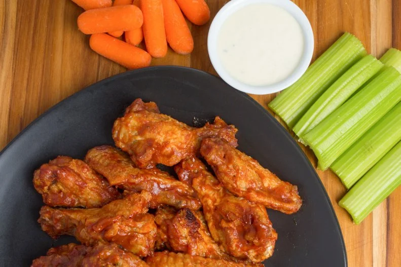 Duff's contribution to the history of the Buffalo wing began in 1969, when founder Louise Duffney first served up chicken wings at this onetime tavern just north of Buffalo. From that point forward Duff's started selling around 20 pounds a week of what were later dubbed its "famous wings." Today the wings are tossed in a sauce customized to your preferred heat level â   ranging from mild to mega-spicy â   and served with the traditional sides of blue cheese, carrots and celery.