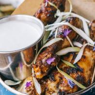 If you love Caribbean spices, you'll love the jerk wings at this Detroit locale. The wings are first bathed in a wet jerk marinade for 24 hours before being cooked for 12 hours. They are then grilled with a dry jerk seasoning â   think flavors of allspice, ginger, garlic and chipotle â   and plated alongside an applewood-smoked blue cheese dressing.