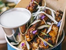 If you love Caribbean spices, you'll love the jerk wings at this Detroit locale. The wings are first bathed in a wet jerk marinade for 24 hours before being cooked for 12 hours. They are then grilled with a dry jerk seasoning â   think flavors of allspice, ginger, garlic and chipotle â   and plated alongside an applewood-smoked blue cheese dressing.