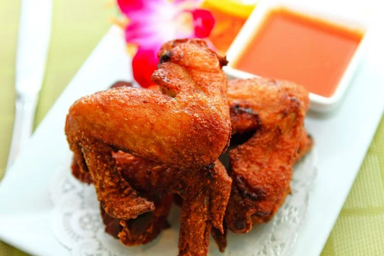 Generations of family recipes have appeared at this authentic Thai restaurant in Los Angeles, now owned by the third generation. On the snacks menu is their famous wings — fried antibiotic-free chicken wings tossed with ingredients like curry, coconut milk, turmeric, fish sauce, lemongrass and garlic, and served up with their own tart Thai BBQ sauce.