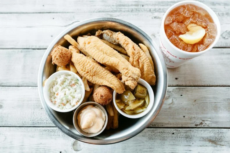 Though neighboring Mississippi is considered the "Catfish Capital of the World," Arkansas loves its catfish. In fact, it would almost be a fun accomplishment to find a place that doesn't serve it on a Friday â   if it weren't so darn delicious. Eat My Catfish serves its namesake item every day of the week. Multiple times per week, its four locations get fresh, farm-raised catfish delivered straight to its doors. Small, well-seasoned fillets are fried in a cornmeal batter until perfectly crisp, then served with the restaurant's signature tartar sauce on the side. Although that omnipresent Arkansas fish is the star of the show, everything on the seafood-focused menu, from the fried or boiled shrimp to the crabs and crawfish, is seriously delicious.