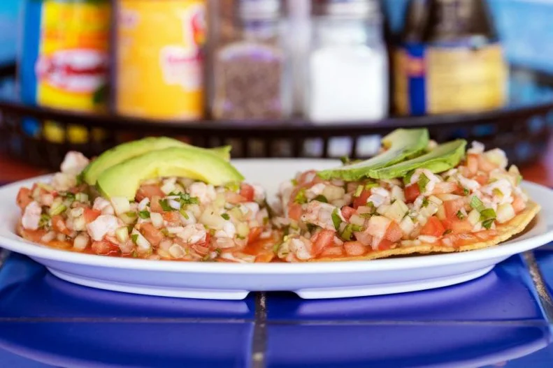 While landlocked Arizona may not have fresh-caught salmon, oysters or shrimp like coastal states, it still has some excellent seafood. Here, it's all about the bright flavors and subtle spice of Mexican-style seafood. The best place in the state to get a taste is Mariscos Chihuahua in Tucson, Nogales and Phoenix. The restaurants feature wild sea-themed murals, a giant fiberglass fish floating from the ceiling and a pleasantly extensive selection of hot sauces to go along with refreshing dishes like ceviche tostadas. The crispy deep-fried tortillas are topped with heaping piles of briny shrimp marinated in lime juice and accompanied by onions, cilantro, tomatoes and avocado.