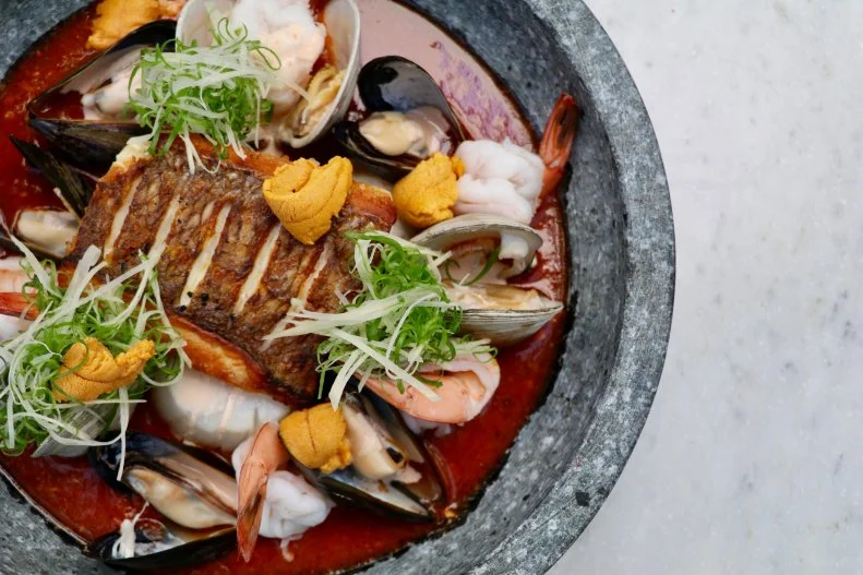 Two of the most-seafood-obsessed countries on the planet are Peru and Japan. When large numbers of Japanese immigrants settled in the South American country and essentially created a new kind of fusion cuisine, called Nikkei, they incorporated a lot of oceanic flavors. That's the focus at famed chef Ricardo Zarate's new restaurant, Once, located in the desert of Las Vegas. Inside the Venetian, he serves upscale Peruvian Nikkei fare like bigeye tuna sashimi with black truffles, Peruvian fried rice with lobster and snow crab, and an aromatic seafood stew with grilled striped bass in a tomato sauce with spicy rocoto-pepper aioli.