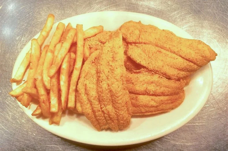 Fried catfish is a staple throughout the South. That allegiance holds true in Kentucky, especially in the western part of the state, where those bottom-dwelling creatures are abundant in the many freshwater rivers and lakes. The best restaurant version is found at Willow Pond Southern Catfish in Eddyville. The folks here use a light breading for their catfish fillets, fry them to a crisp brown and serve them accompanied by impeccable sides like hush puppies, vinegar slaw, baked potatoes and white beans. Each table has a container of sweet red pepper relish that most guests use to spice up the beans and whatever else they please.