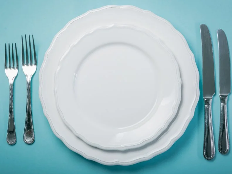 Intermittent fastin concept - empty plate on blue background, copy space