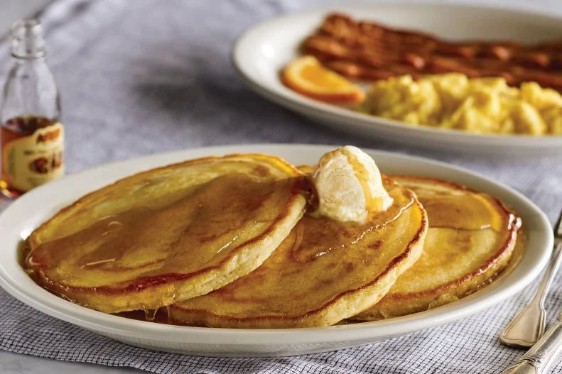 At Cracker Barrel, all-day breakfast is more of a birthright than a lifestyle choice. It's also the reason why Momma's Pancake Breakfast is the restaurant chain's most-popular dish. This plate is nothing short of an ode to breakfast: Three hot-off-the-griddle buttermilk pancakes come outfitted with butter and syrup plus two eggs and thick-sliced bacon or sausage on the side.