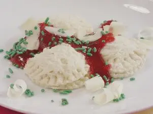 PB and J Ravioli prepared by Food and Lifestyle Expert, Brandi Milloy using two pieces of bread a biscuit or cookie cutter.  Use the cookie cutter to cut a circle on both slices of bread.  Put a little bit of peanut butter directly in the middle.  Close the "ravioli" with the other side of bread and using a fork, press down on the edges to close the "ravioli".  Drizzle melted rasberry jam on top.  Garnish with shaved white chocolate to resemble parmesean cheese, as seen on Let's Eat!, Season 1.