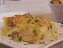 Pasta Pierogi Lasagna was prepared by Chef Stuart O'keeffe. He begins with leftover mashed potatoes that he has heated up. He then adds 1 lb. of ground beef and 8 oz. of italian sausage to a pan and begins to cook them together. While Food and Lifestyle Expert Brandi Milloy cooks the meat of the stove, Chef Stuart O'keeffe makes a roux by melting butter in a warm pan. Once it starts to melt, add and whisk together 4 tablespoons of flour and 4 tablespoons of butter. After it has combined, add in warm milk, stirring as you pour. Whisk together until the mixture thickens. Add in sharp cheddar cheese and mix, seasoning with salt and pepper. Pour a layer of the roux on the bottom of the casserole pan. Next add noodles on top of the roux layer. Food and Lifestyle Expert Brandi finished cooking the meat, removed it, and began to cook the cabbage in the pot. She then added the meat back into the cabbage and combined. Layer the meat and cabbage layer on top of the noodles, then mashed potatoes, then the cheese roux, and repeat. Finish with parmesan cheese and cook for 30-40 minutes on 375 degrees, or until golden brown. Remove, cut, and serve, as seen on Let's Eat, Season 1.